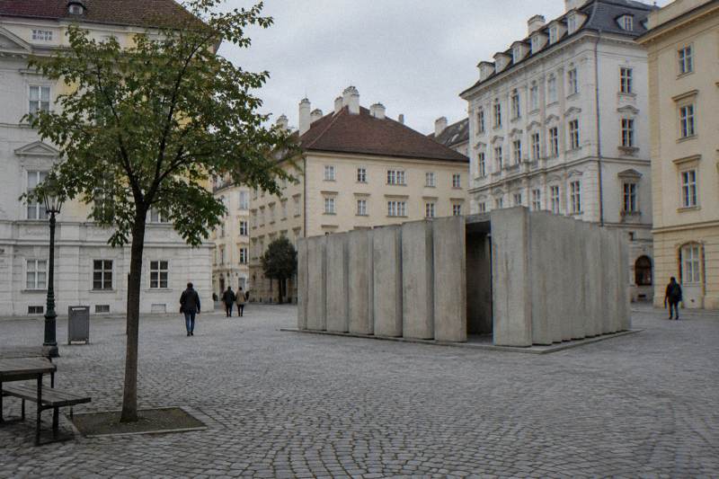 The pale concrete library-shaped memorial on the cobbled Judenplatz, seen from across the square.