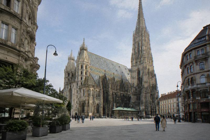 Late morning on Stephansplatz, with the Gothic south tower and patterned tile roof of St. Stephen's Cathedral rising above the paving.