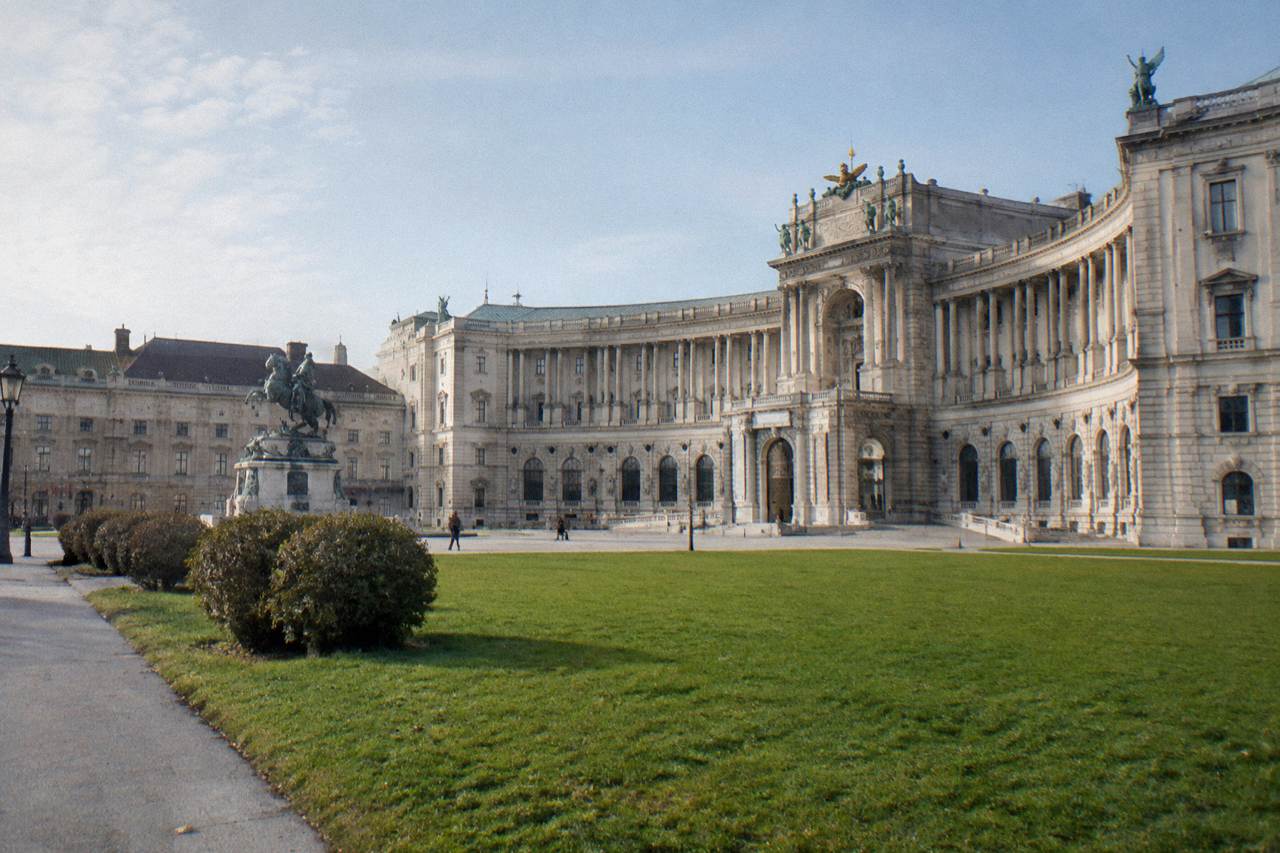 Heldenplatz seen toward the curved Neue Burg wing on a bright morning with empty lawn