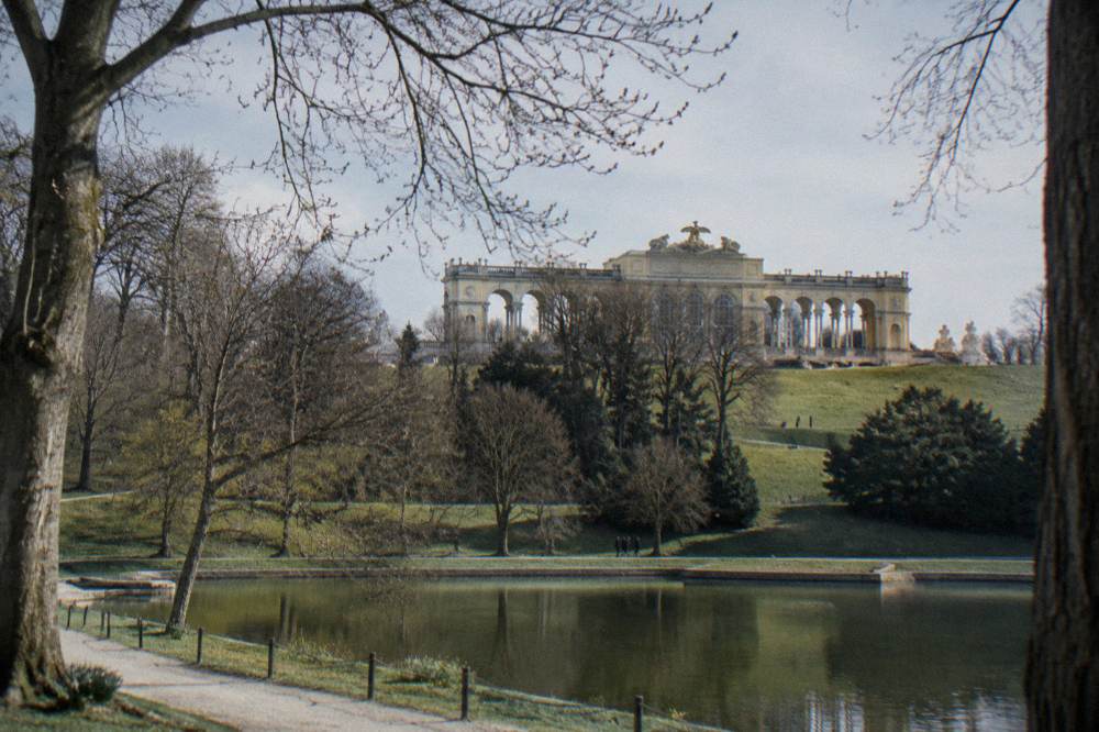 The Gloriette colonnade on its hill above the Schönbrunn park seen through bare early spring trees