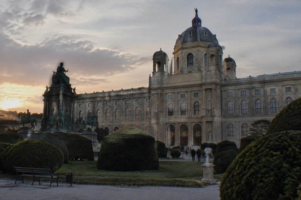 The Naturhistorisches Museum facade across Maria-Theresien-Platz in low evening light with columns and steps