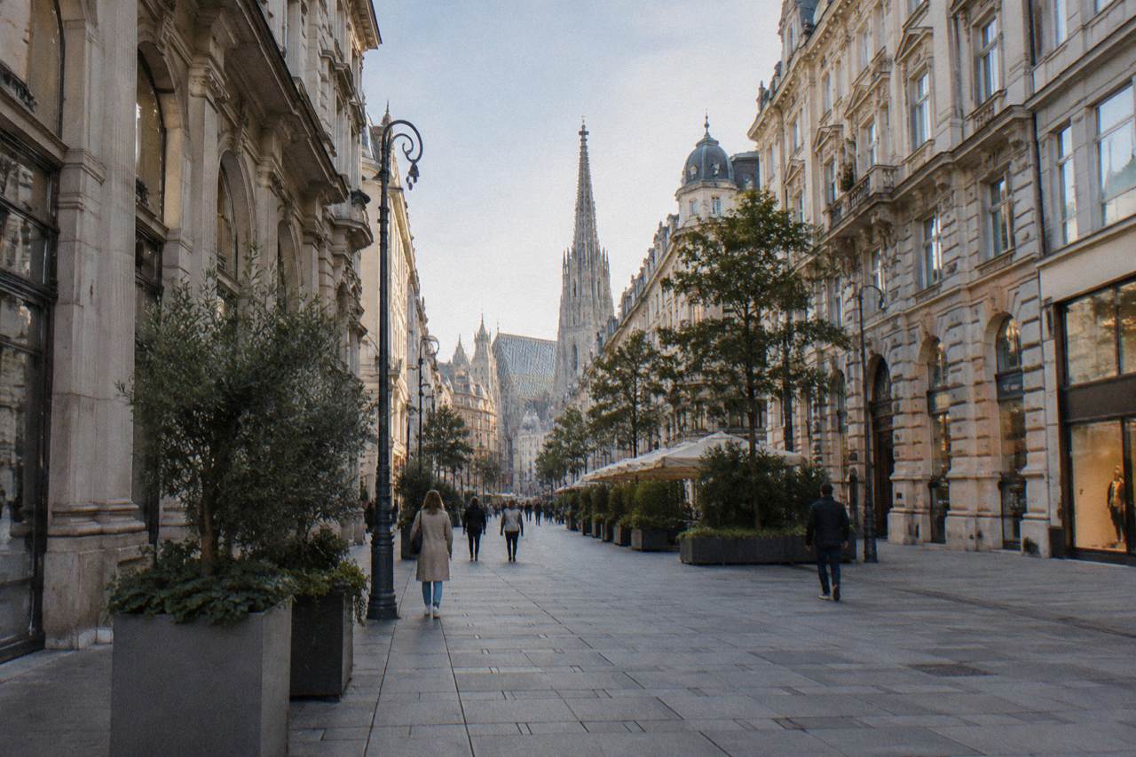 The pedestrian Kärntner Strasse sweeping toward the cathedral spire seen from the Opernring end with open pavement
