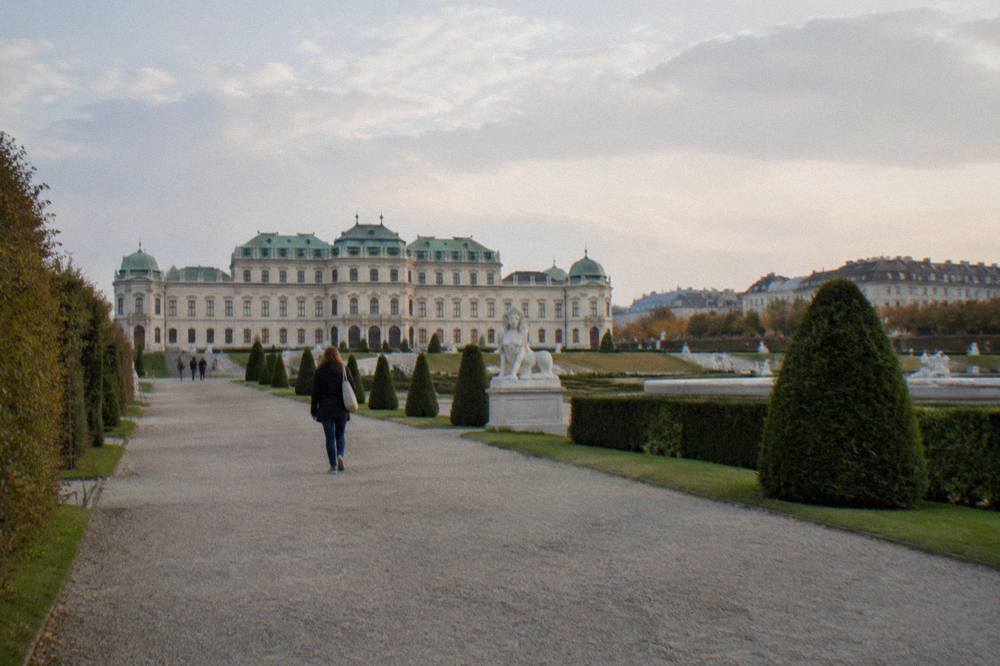 Gravel paths and trimmed hedges of the Belvedere garden with the Upper Belvedere behind